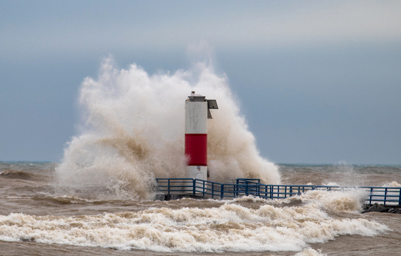 Wave crashing into a pier head light